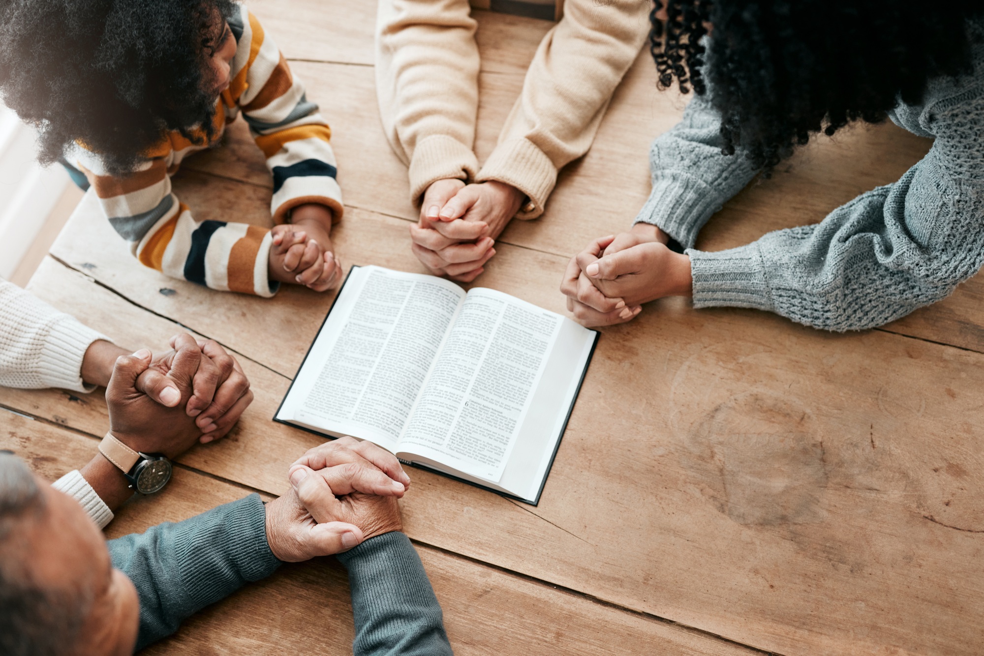 Bible, reading book or hands of family in prayer, support or hope in Christianity home for worship